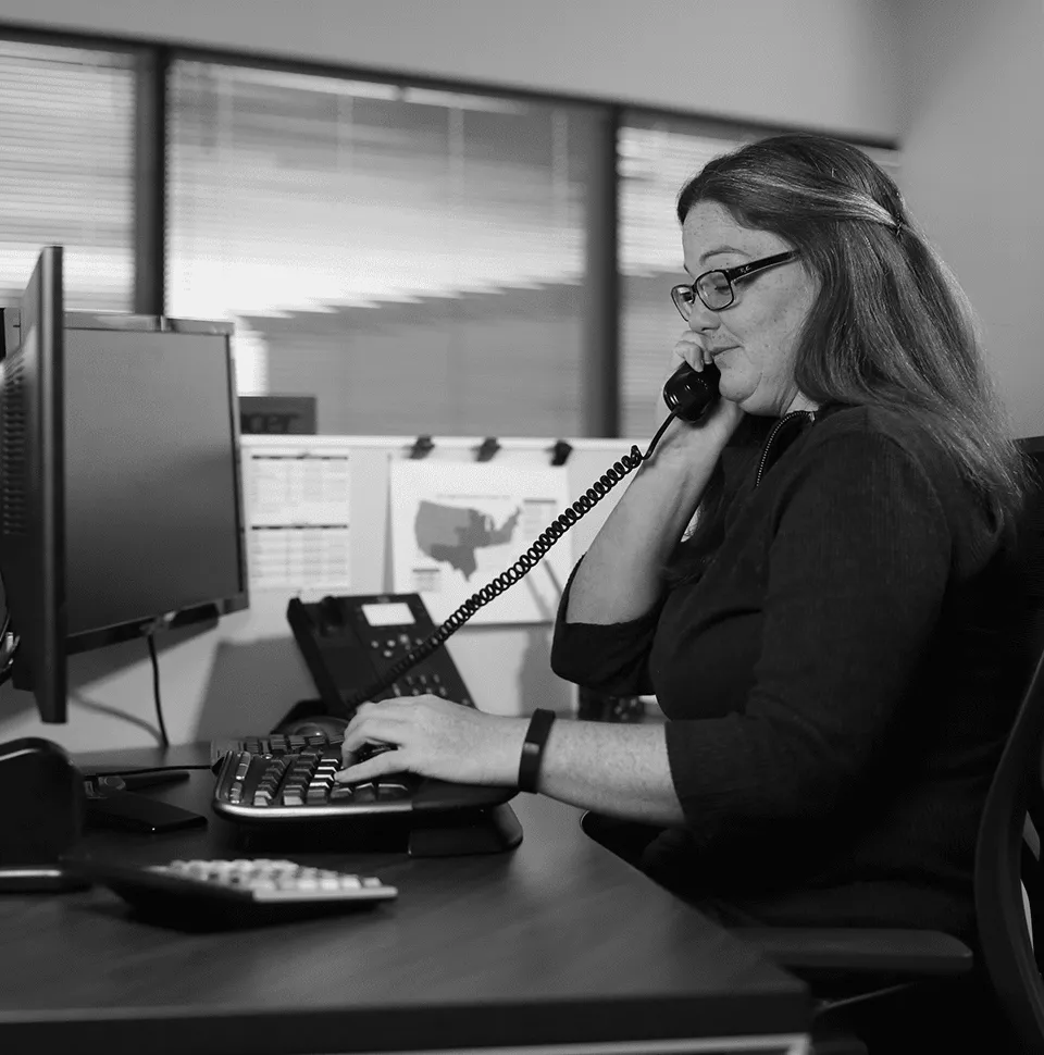 Customer Focus Core Value 960x970 DCLI employee answering phone in the office