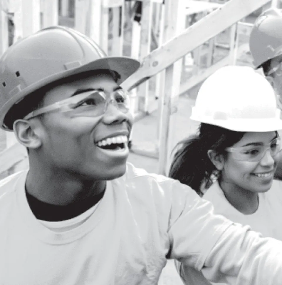 Two students helping to build a house