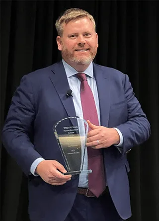 Newitt and Award 320x445 Thumbnail image of DCLI President holding award