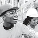 Two students helping to build a house